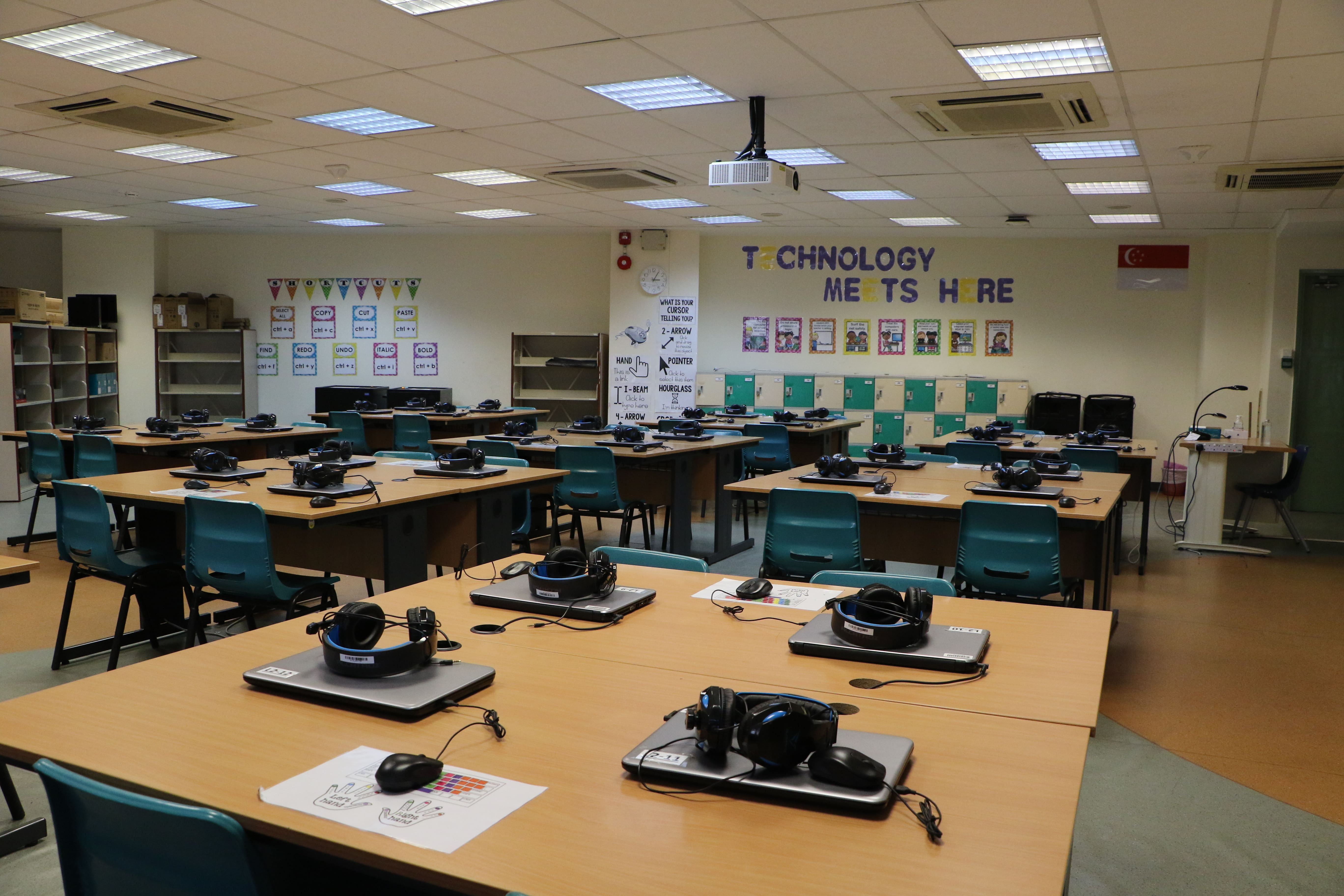 Computer lab equipped with laptops, headsets and technology learning stations.